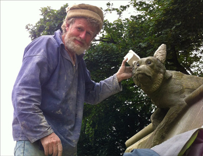 Photo of Tom Clark repairing a wolfs ears