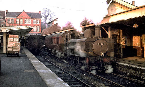 Photo of Merthyr Tydfil railway station in 1963 with steam train leaving for Hirwaun