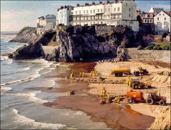 Photo of Castle Beach being cleaned in 1996 after Sea Empress grounding