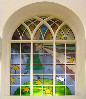 Photo of stained glass window in Feed My Lambs hall