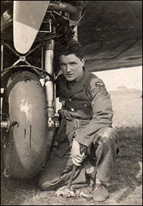Portrait of John Elwyn Owen beside an aeroplane
